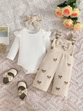 White ribbed baby bodysuit with beige bow-embroidered overalls and matching headband displayed flat