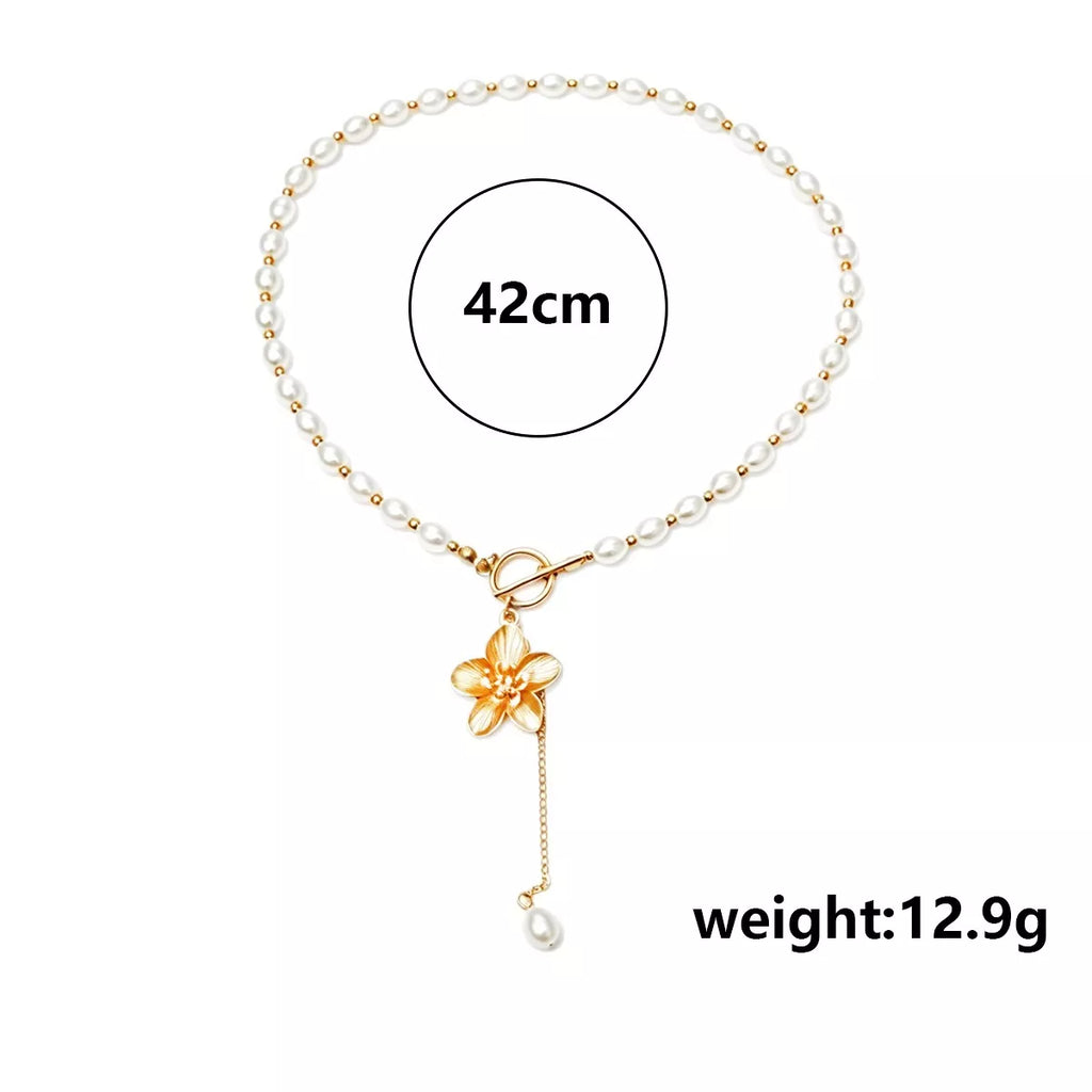Measurements diagram for pearl-like bead choker with gold-tone flower clasp and long pendant