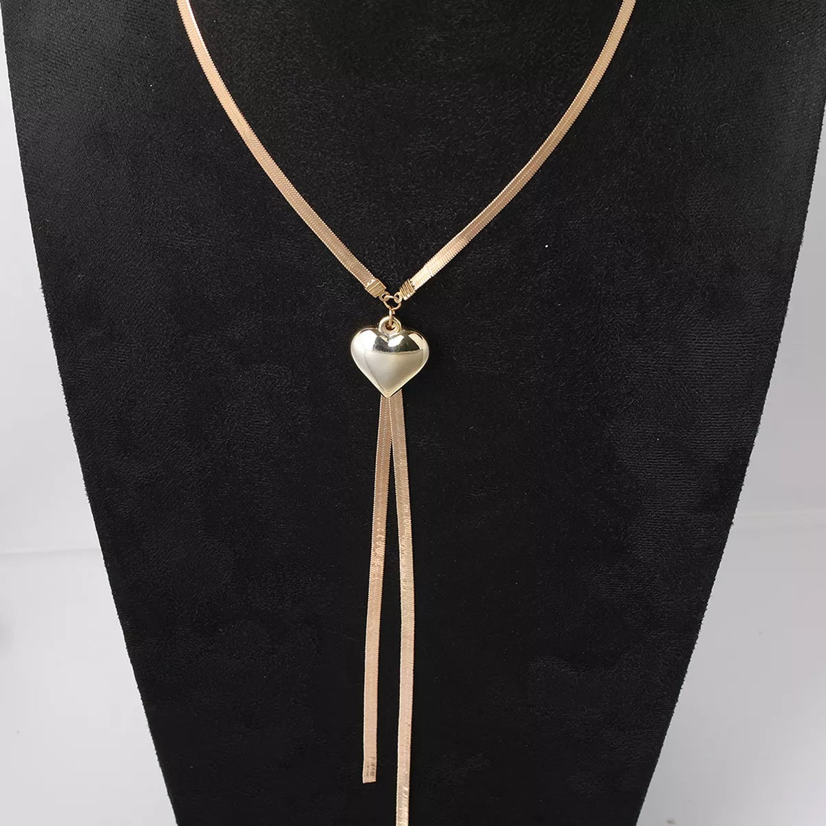 Gold-tone heart pendant lariat necklace with long chain tassels