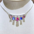 Silver-tone necklace with blue and pink teardrop stone pendants — detail view