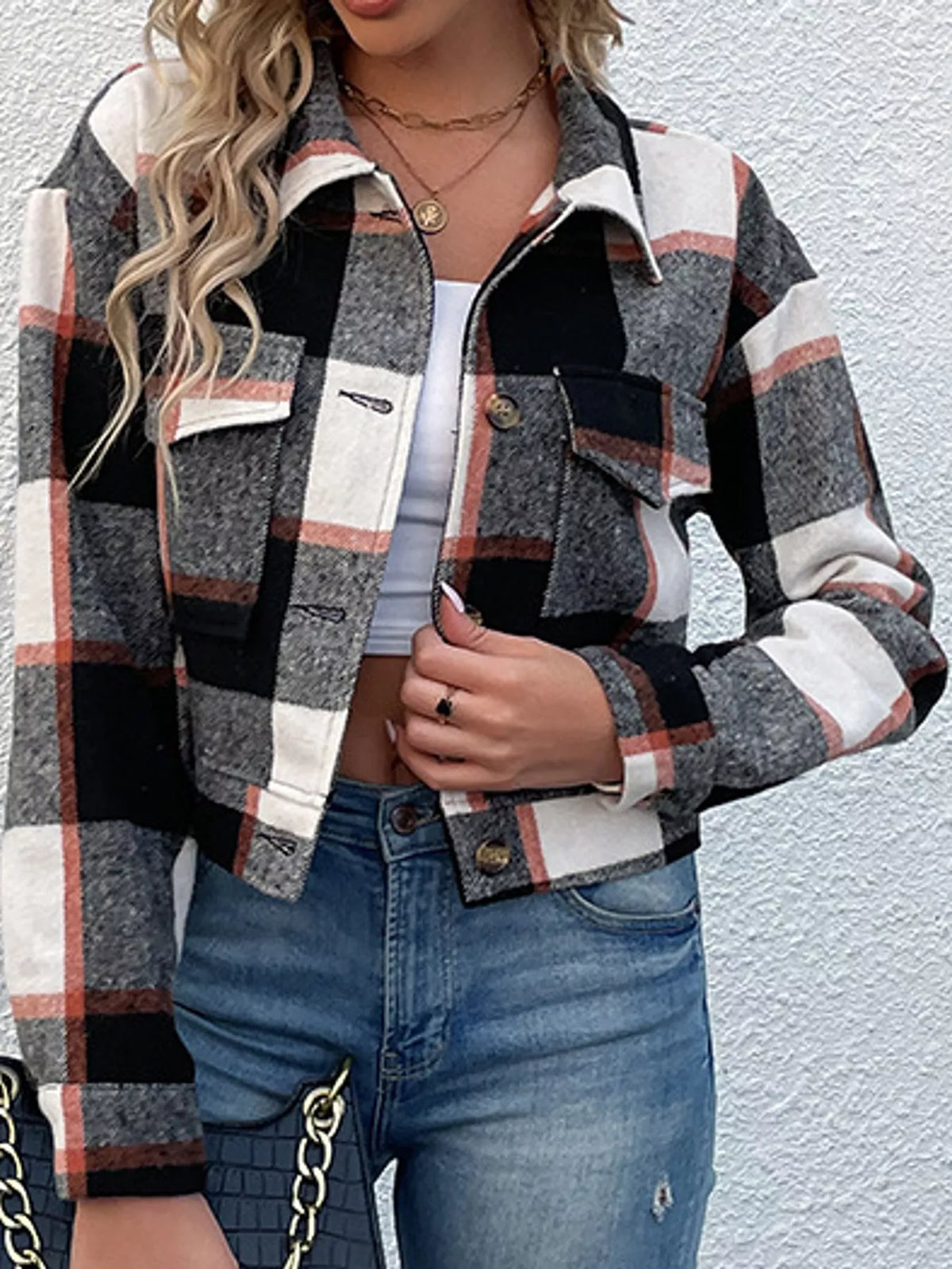Black color-block plaid cropped jacket with flap chest pockets, front view.