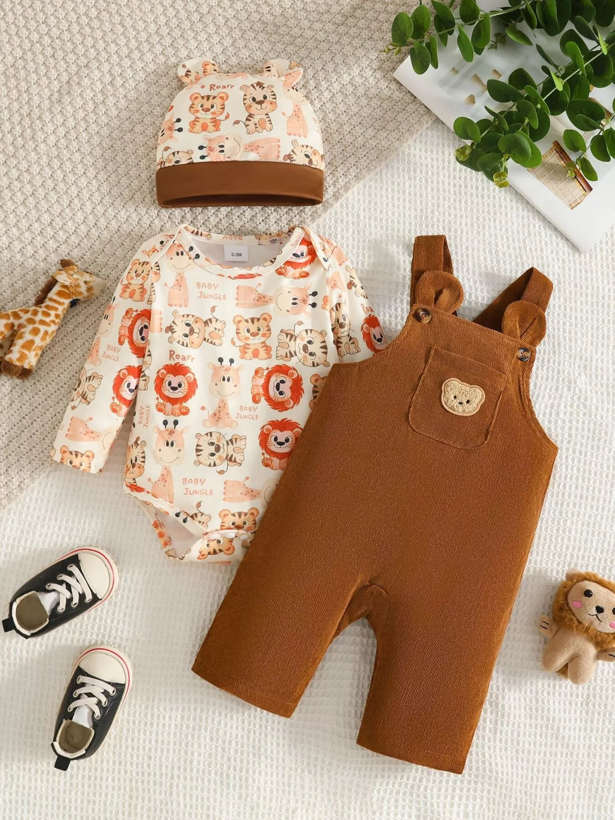 Brown corduroy overalls, animal-print long-sleeve top and matching hat displayed flat