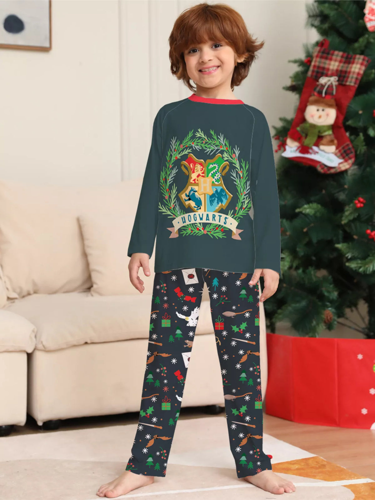 Dark green Hogwarts graphic pajama top with black patterned pants worn by a child