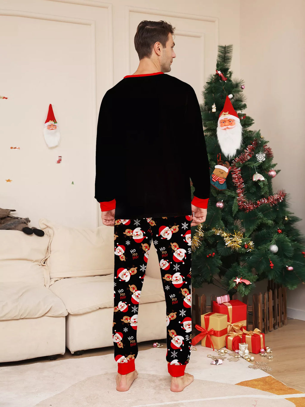 Back view of the men's black top and Santa-print pajama pants.