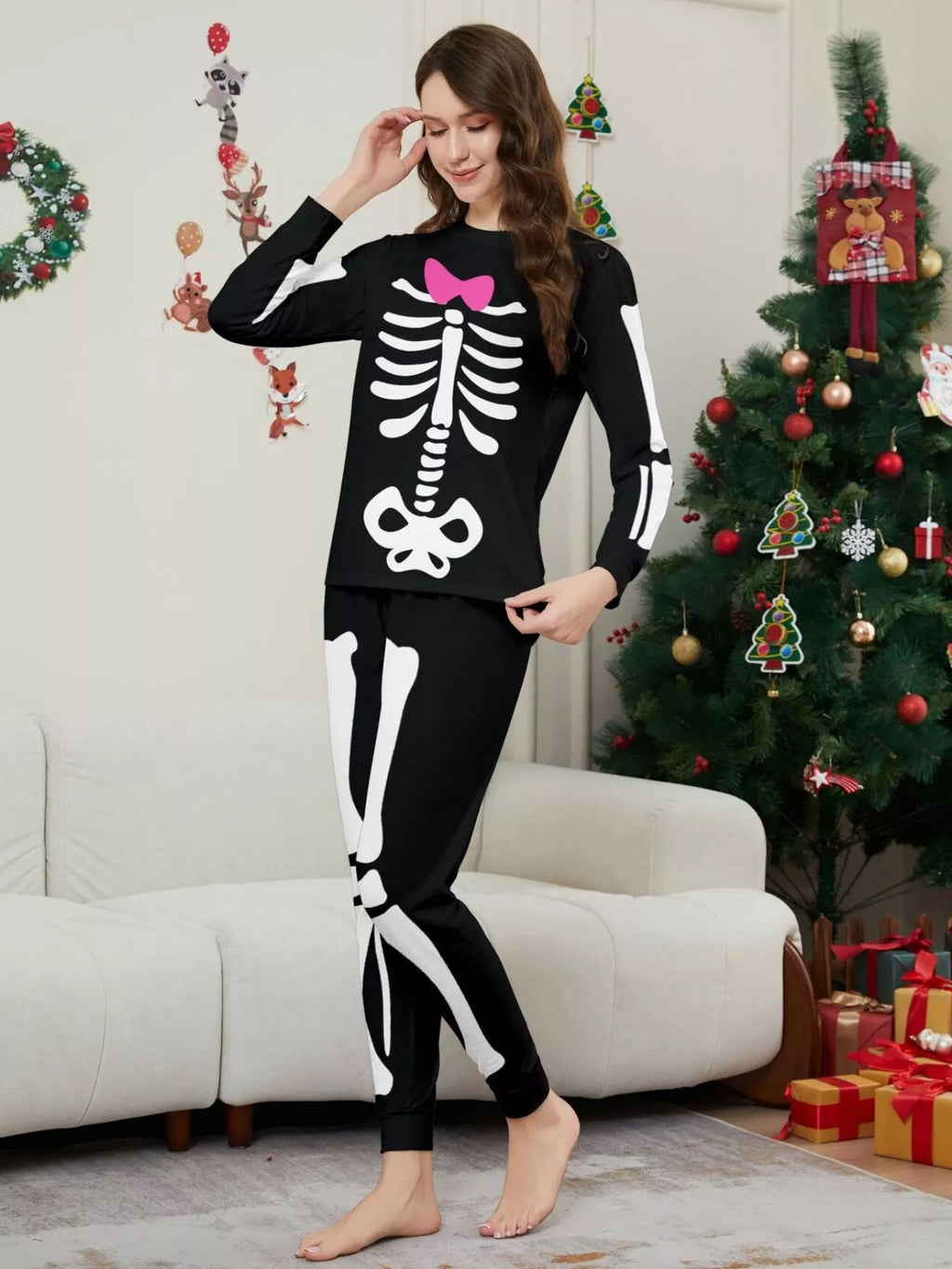 Angled view of the women's skeleton pajamas with pink bow detail.