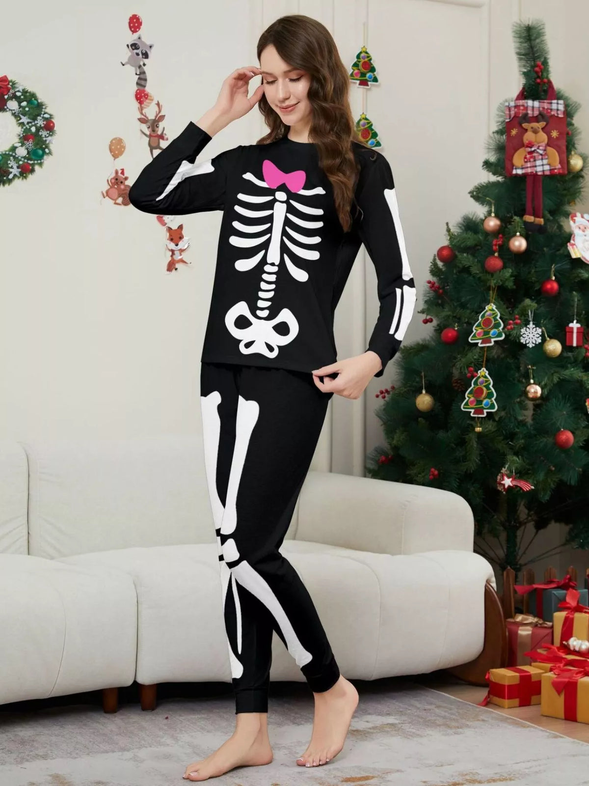 Angled view of the women's skeleton pajamas with pink bow detail.