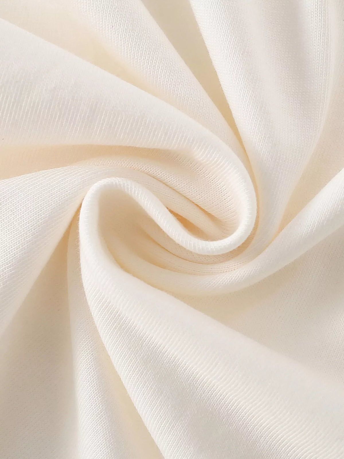 Folded cream fabric showing the top's texture.