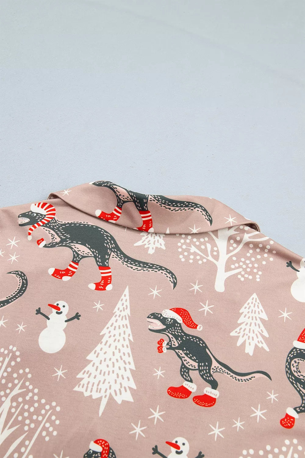 Pink long-sleeve pajama shirt and pants with dinosaur Christmas print — back view