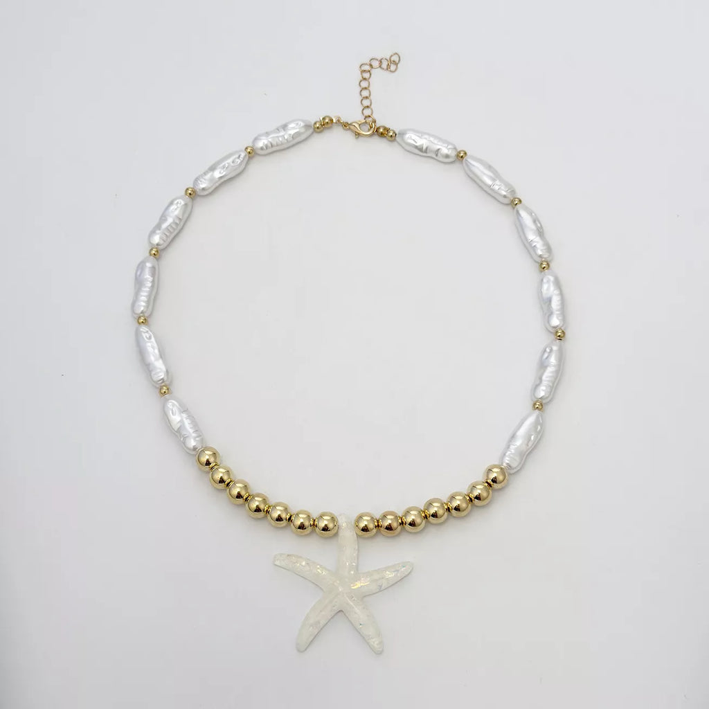 Starfish pendant necklace with gold-tone beads and white shell-like links