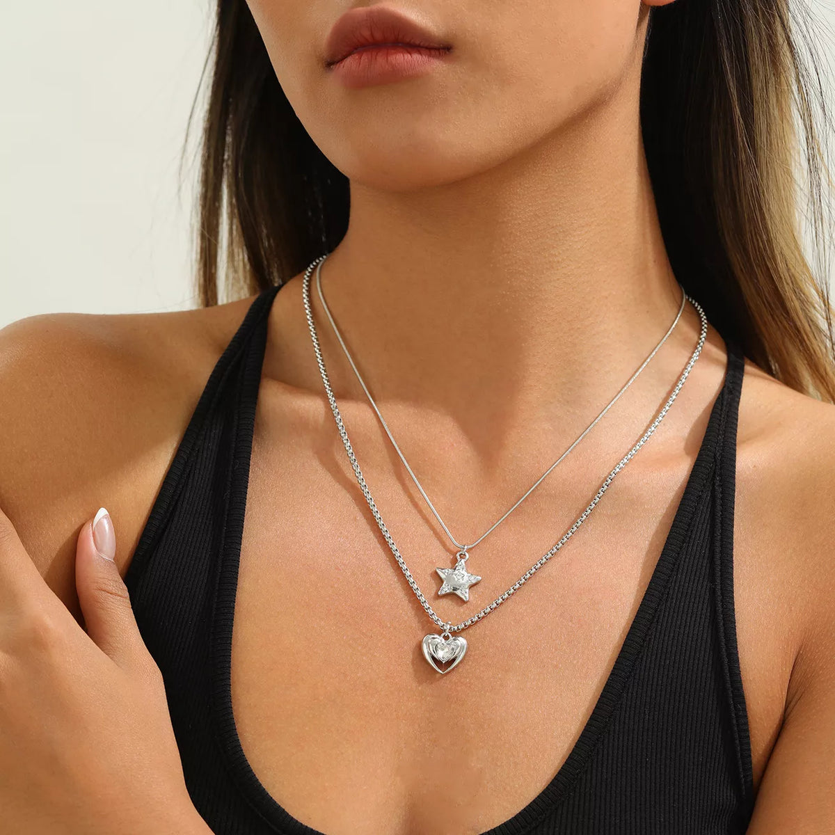 Layered silver-tone star and heart pendant necklaces