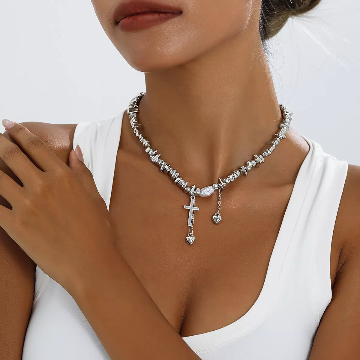 Chunky silver-tone chain necklace with cross and dangling charms