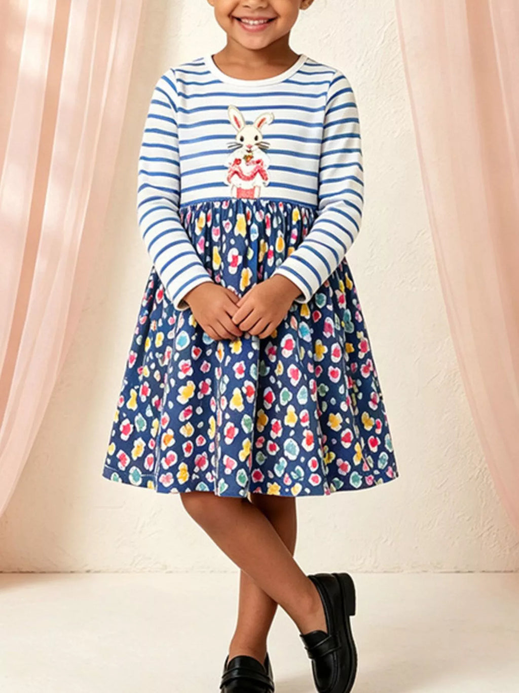 Blue and white striped bunny graphic dress with a dark floral skirt worn by a child
