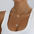Layered gold-tone moon and coin pendant necklace