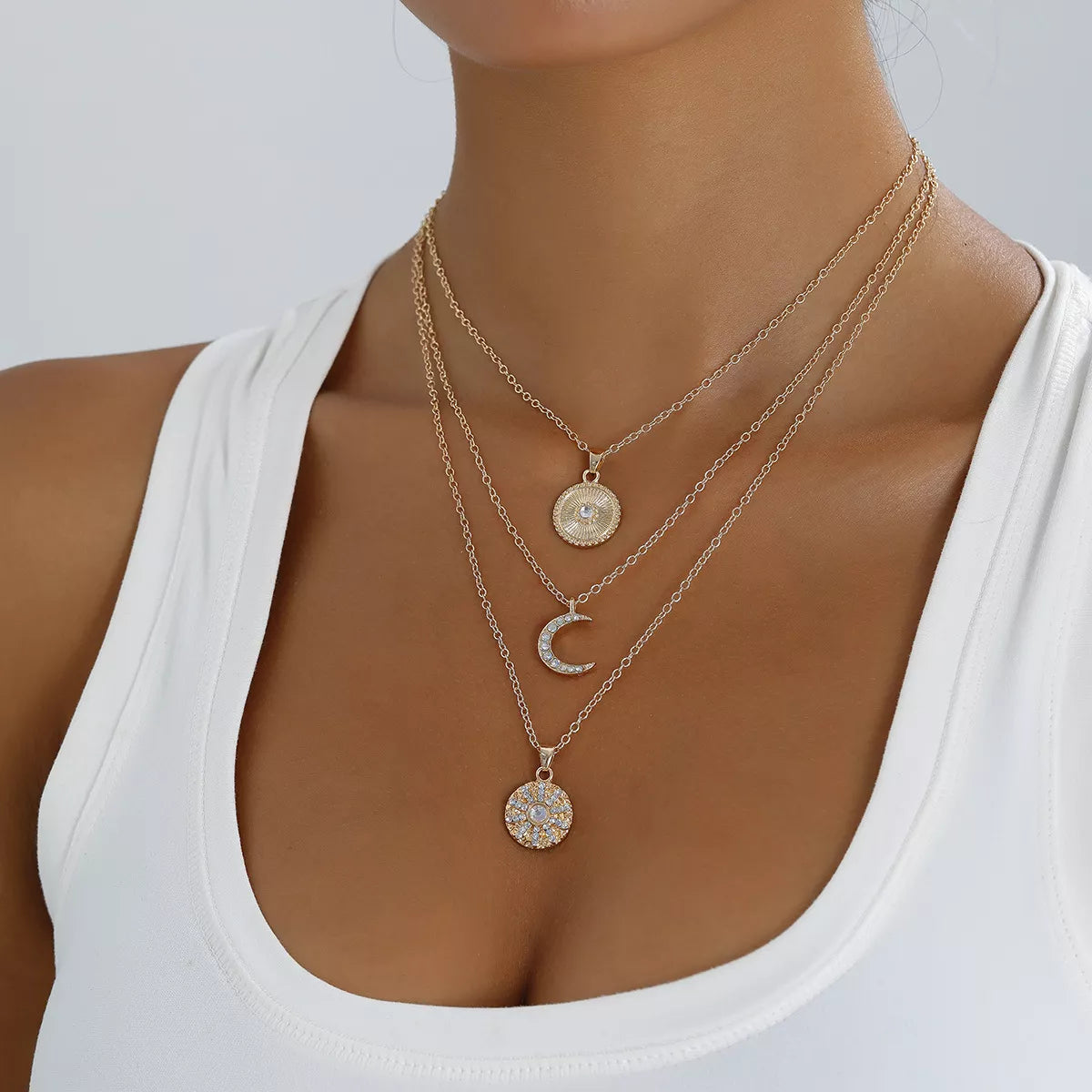 Layered gold-tone moon and coin pendant necklace