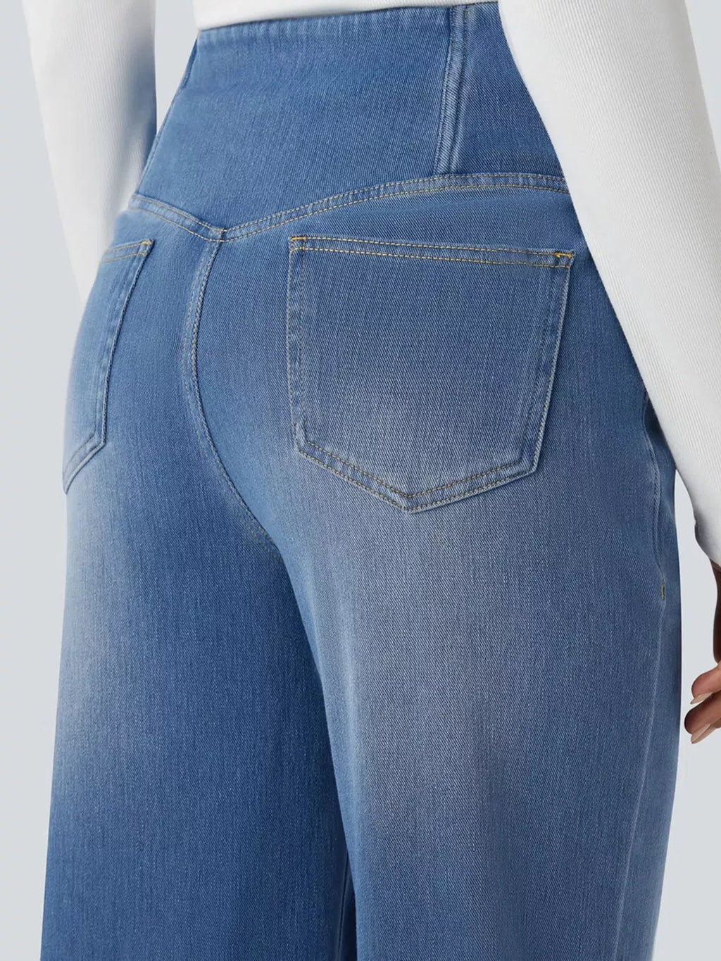 Light blue high-waisted crossover waistband straight-leg jeans — back view