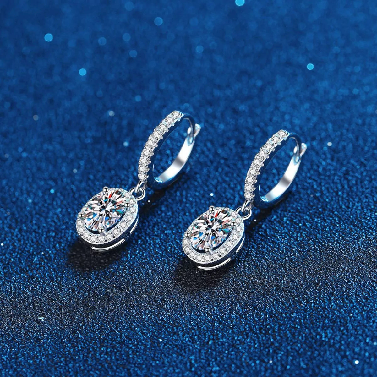 Silver-tone hoop earrings with oval halo stone drops — detail view