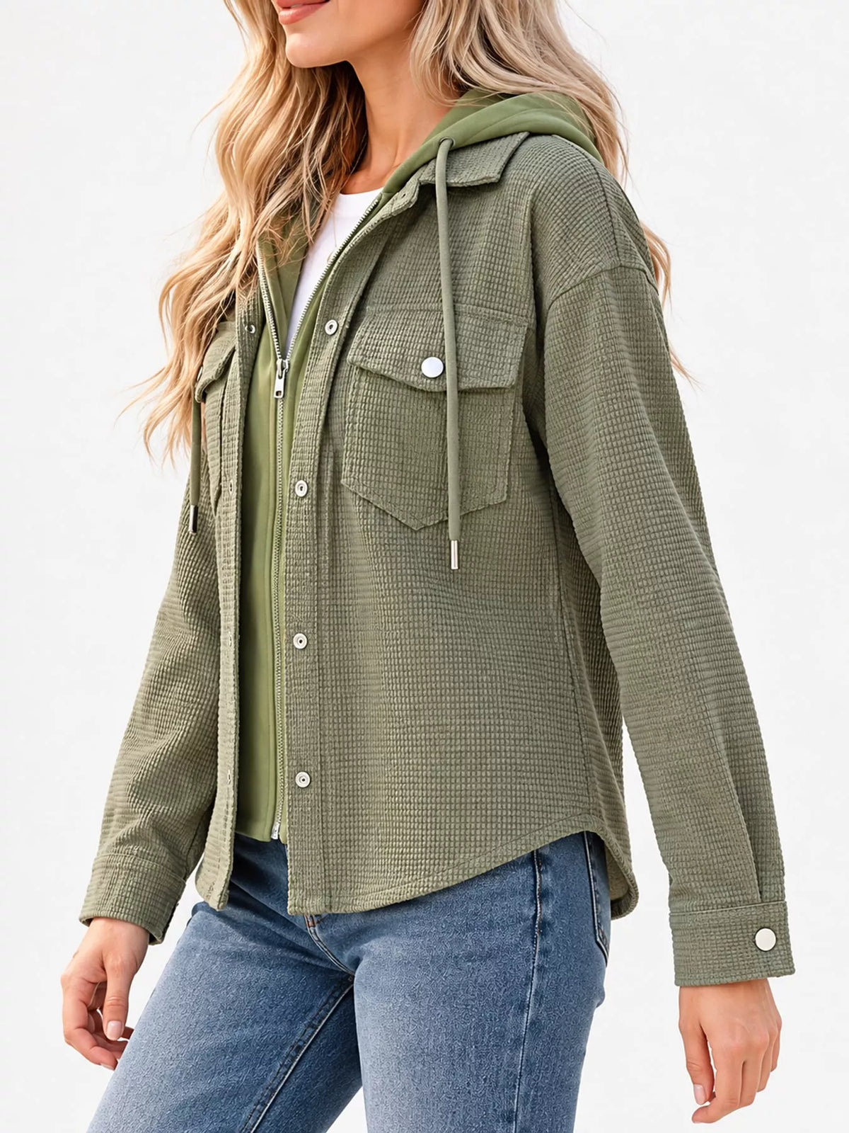 Side view of the green jacket and curved hem.