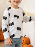Child wearing a white long-sleeve top with black bat prints.