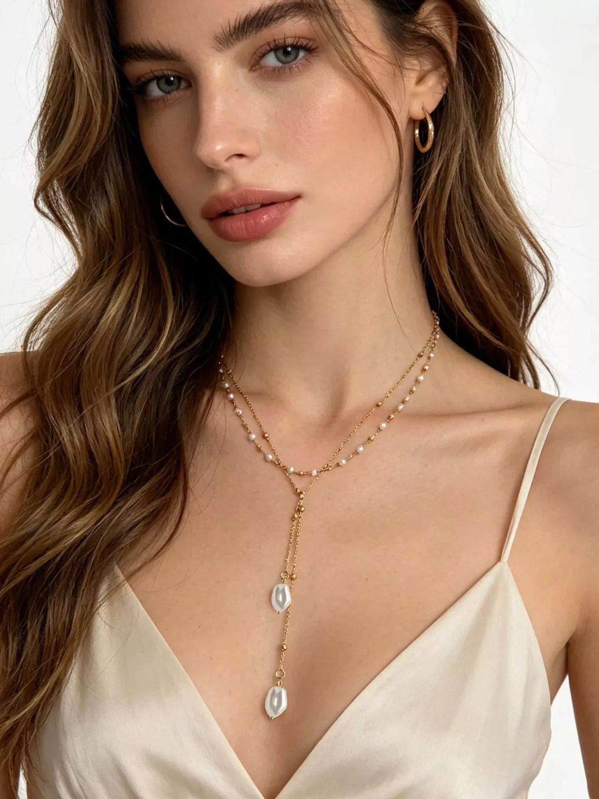 Gold-tone layered Y-shaped necklace with pearl-like pendants