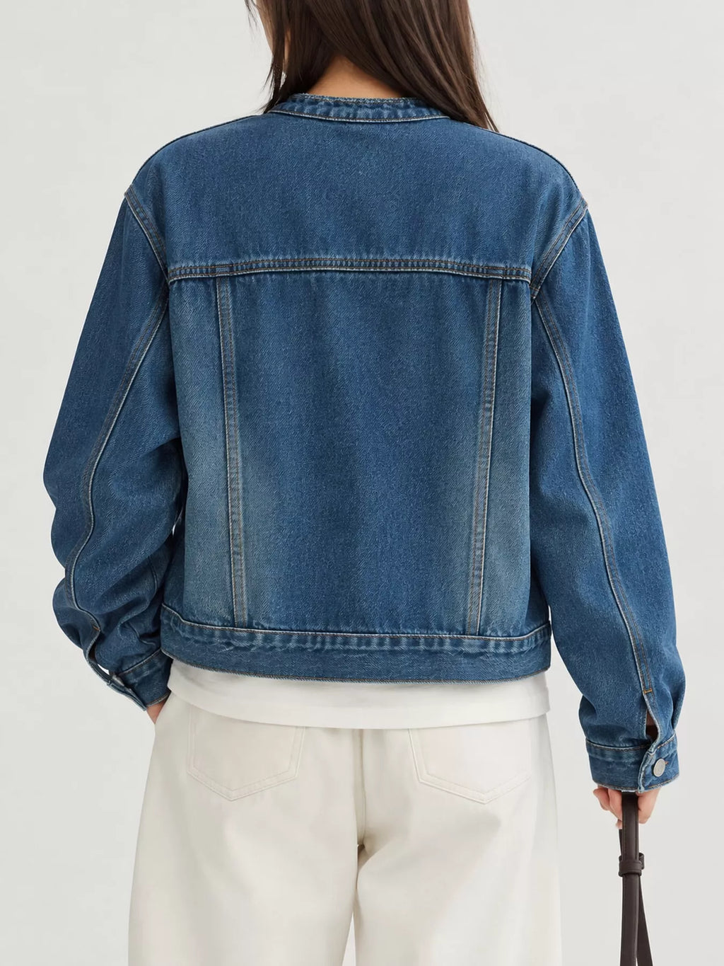 Back view of the blue cropped denim jacket.