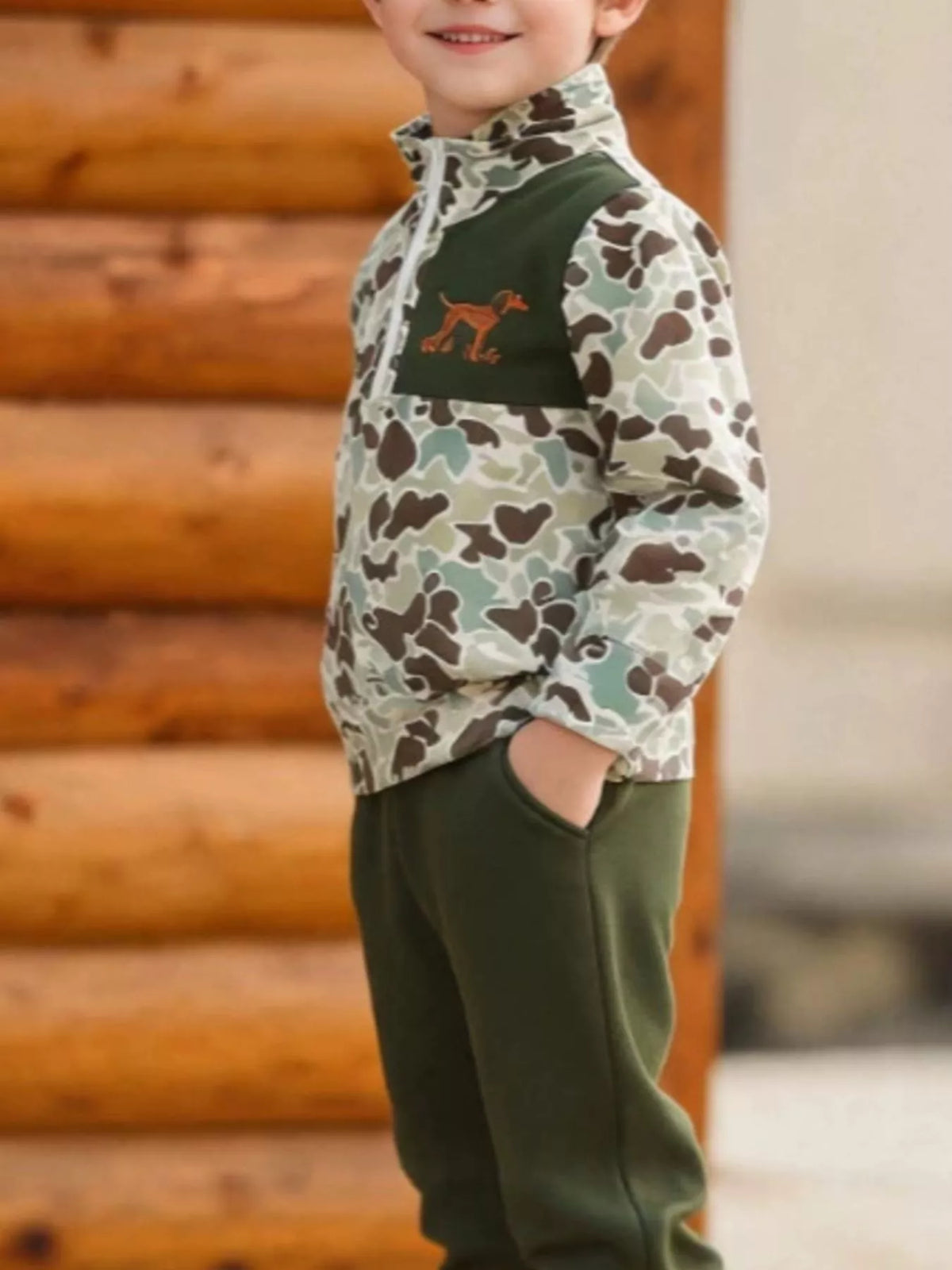 Green camouflage quarter-zip top and olive joggers worn by a child