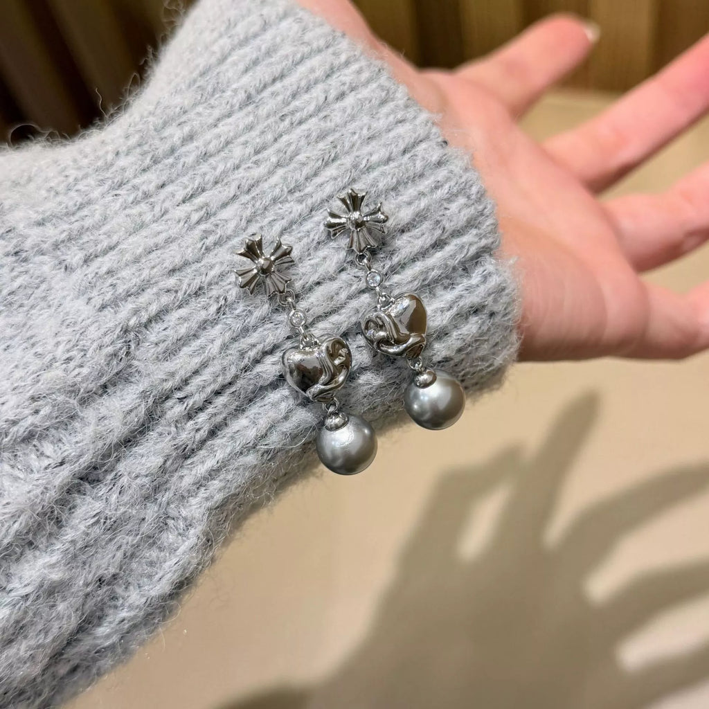 Heart-shaped drop earrings with gray pearl-like beads — detail view