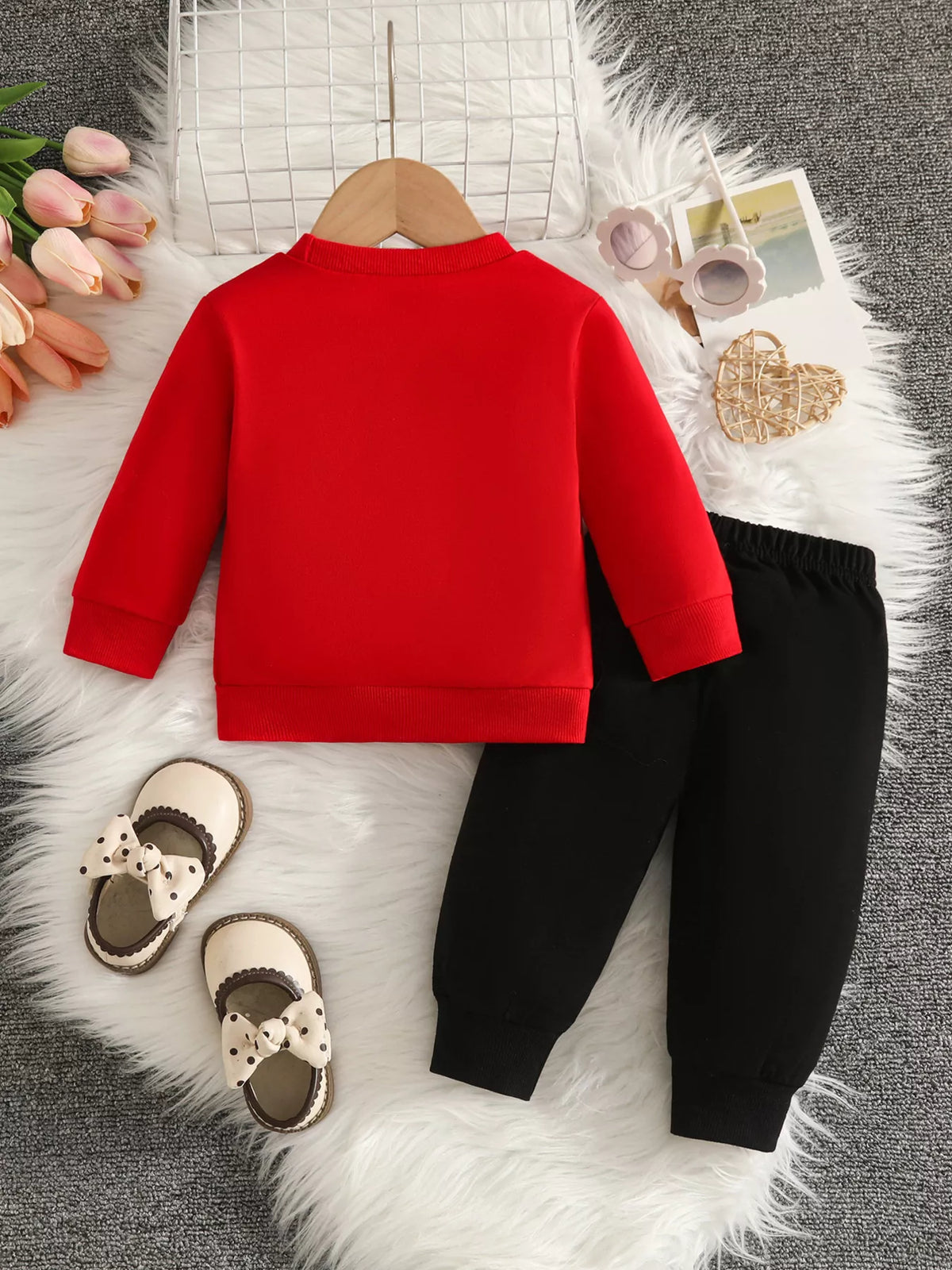 Back flat lay of a red top and black pants.