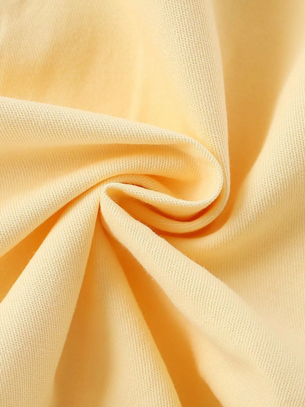 Smooth yellow fabric detail of the children’s coat