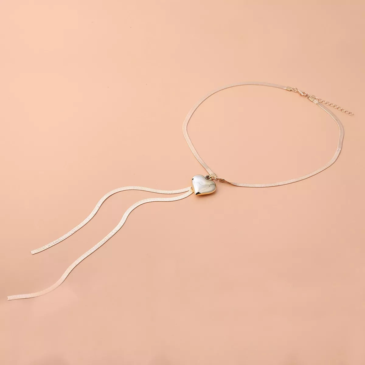 Gold-tone heart pendant lariat necklace with long chain tassels