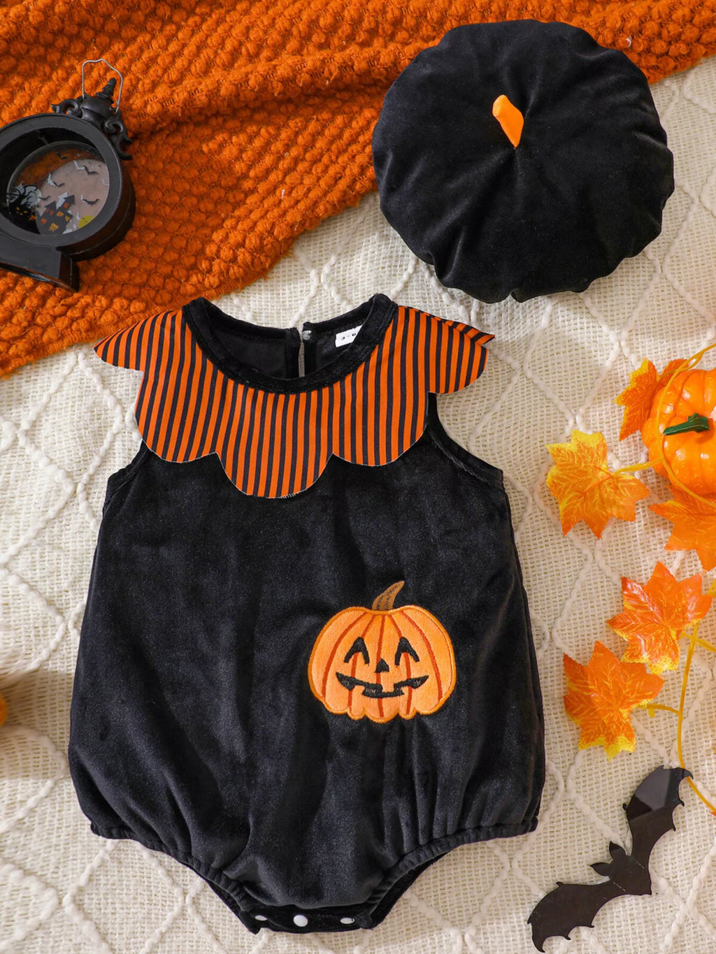 Halloween sleeveless baby bodysuit with striped yoke and matching beret-style hat displayed flat