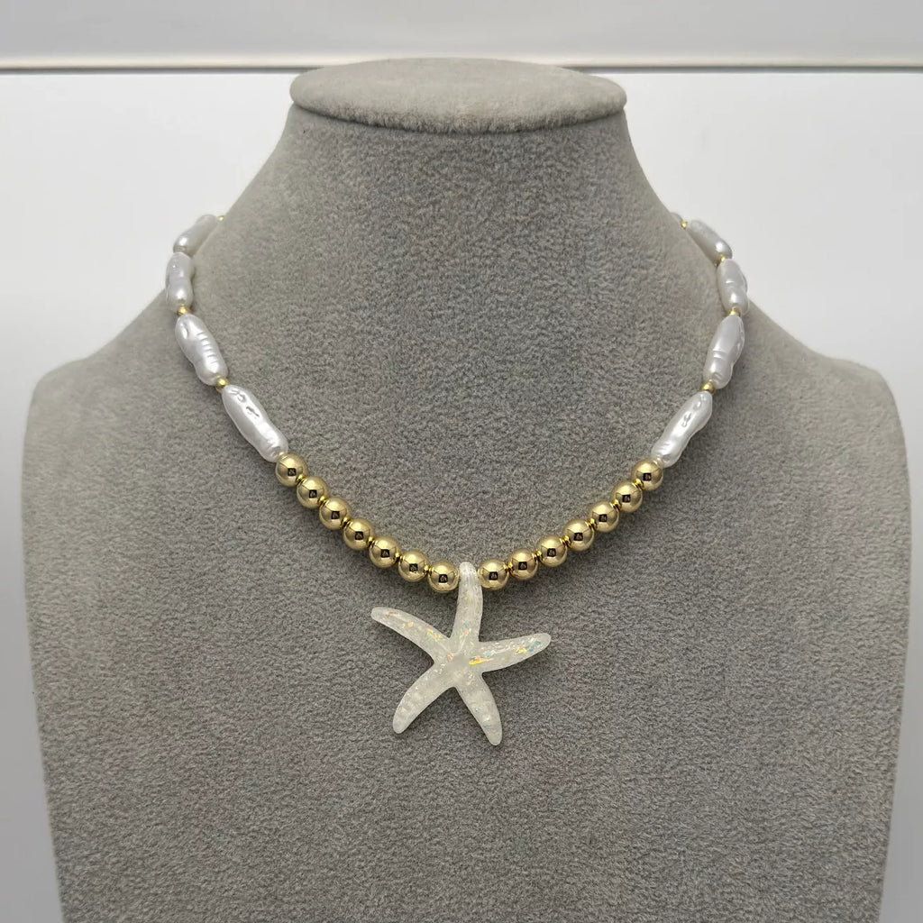 Starfish pendant necklace with gold-tone beads and white shell-like links