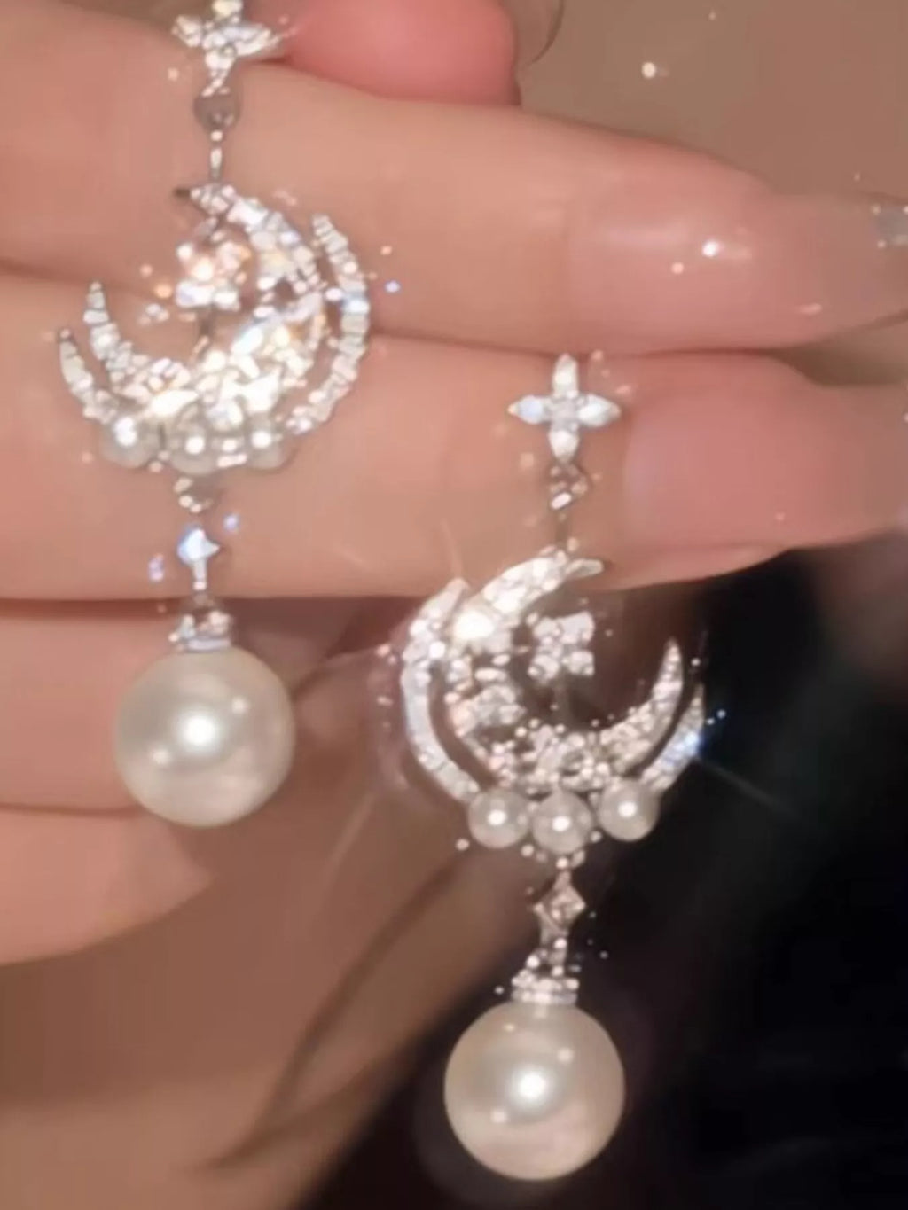 Moon and star dangle earrings with pearl-like bead drops — detail view