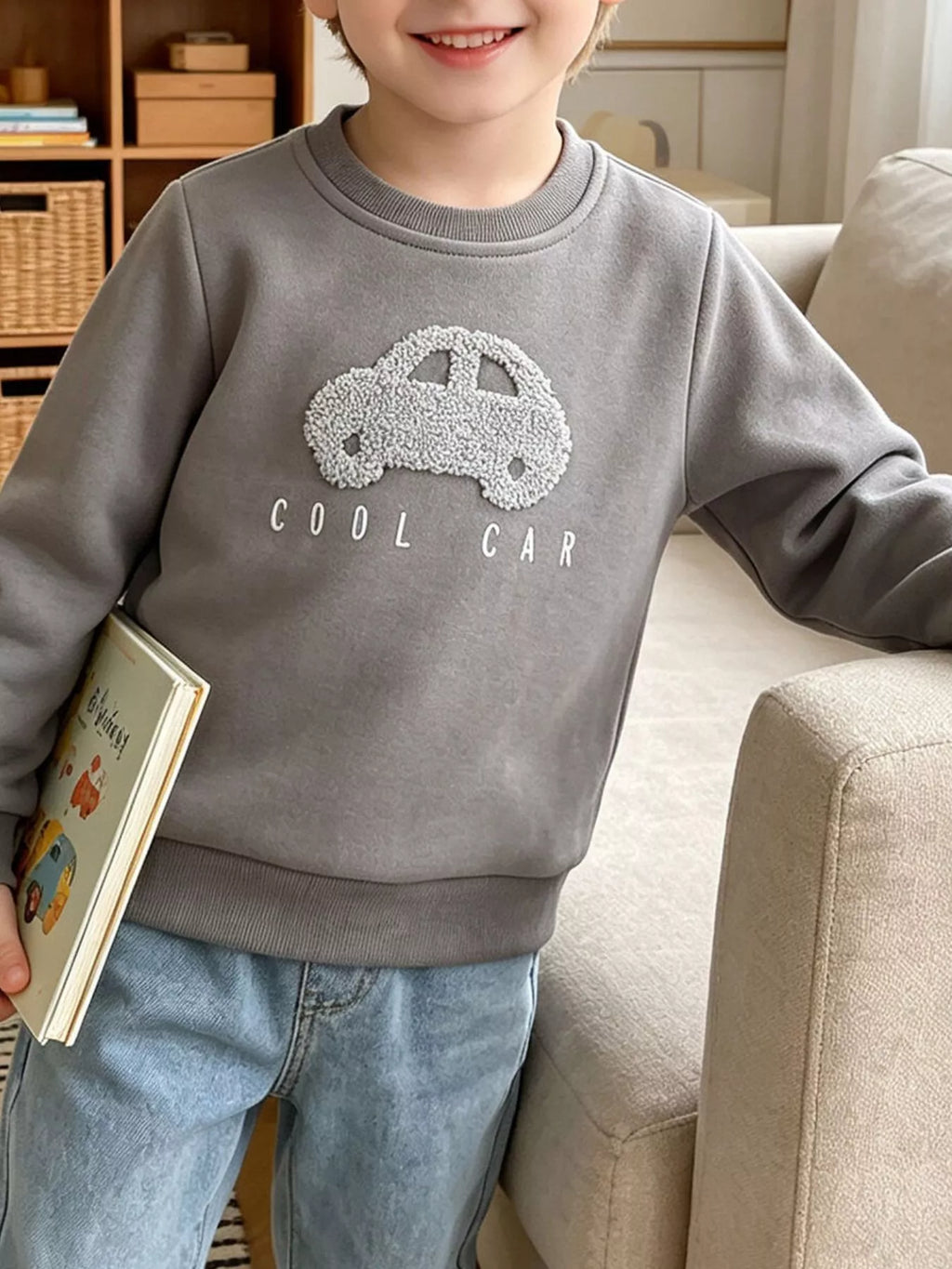 Child wearing a gray sweatshirt with textured car applique and Cool Car lettering.