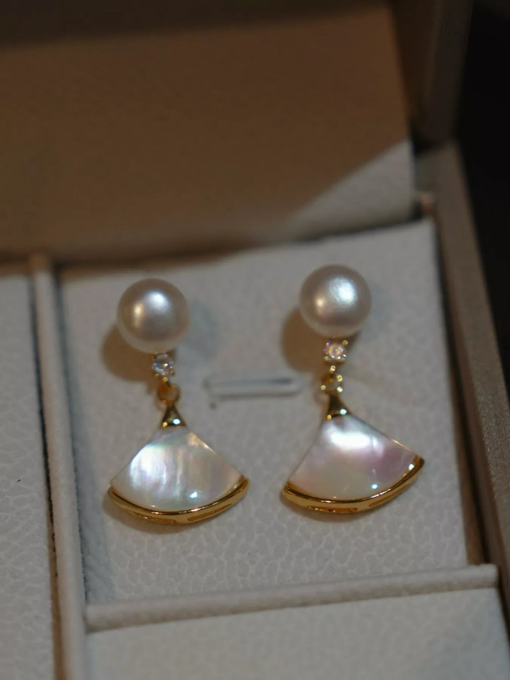 Fan-shaped drop earrings with pearl-like beads and gold-tone edges — detail view