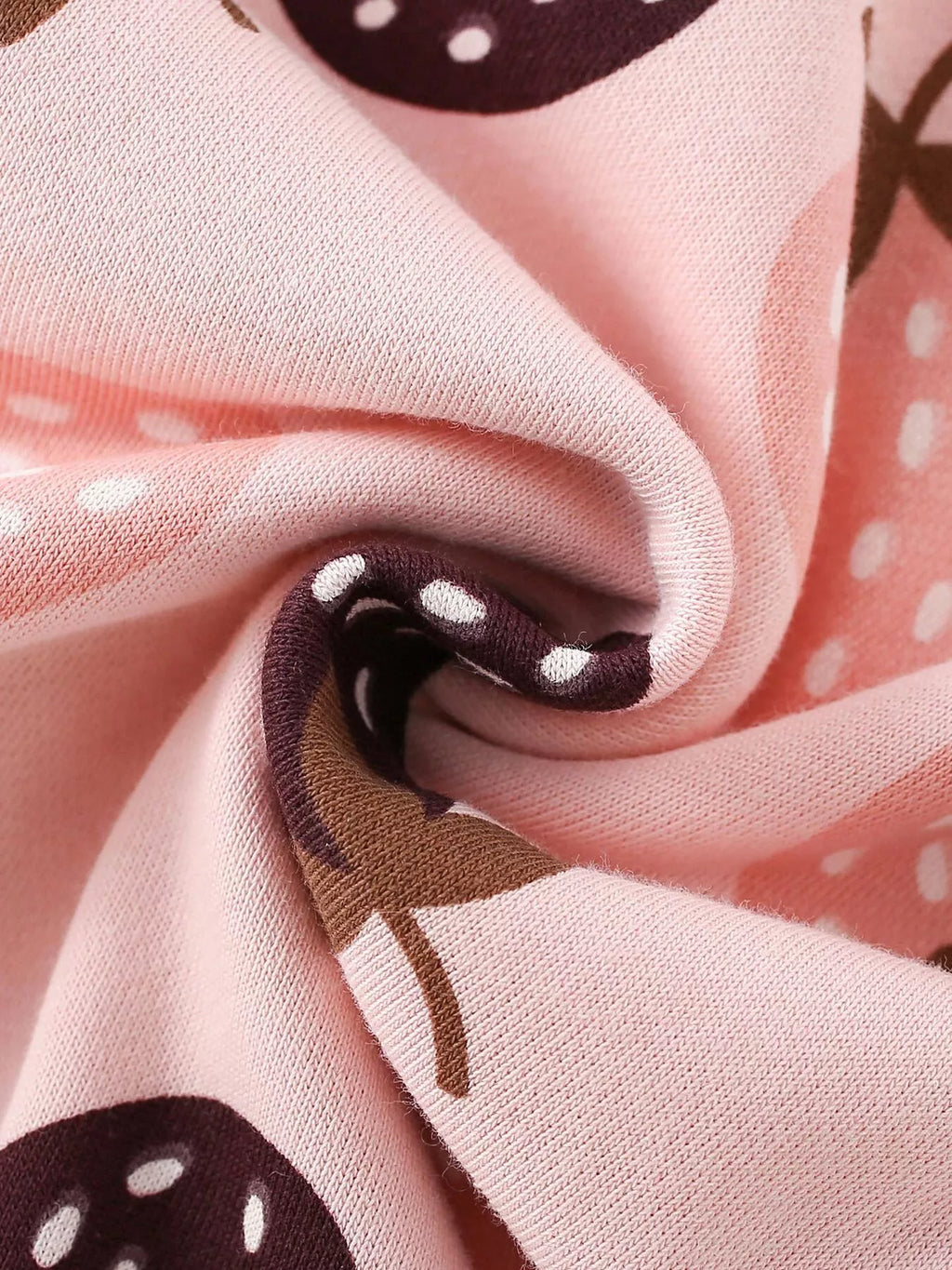 Folded pink strawberry-print sweatshirt fabric.