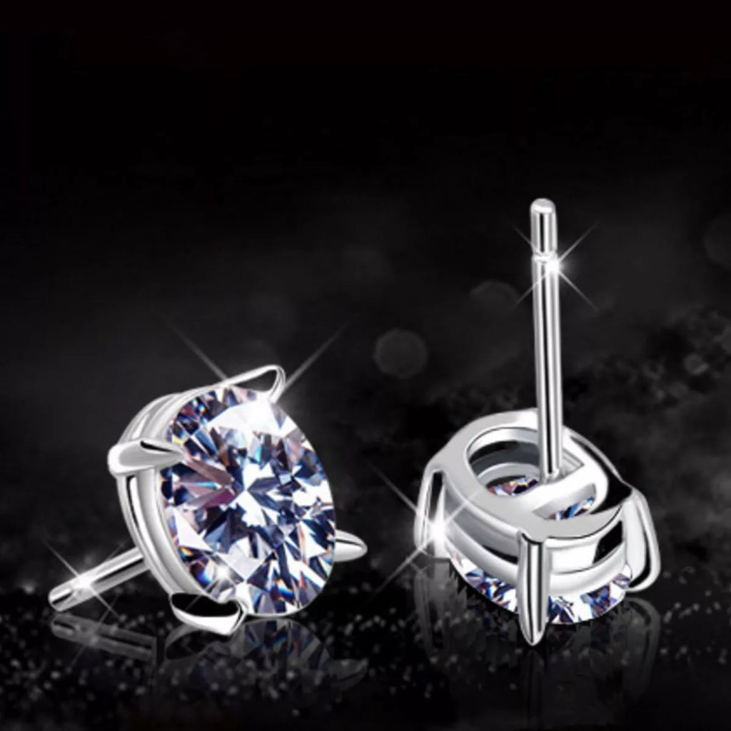 Silver-tone stud earrings with clear faceted stones — detail view