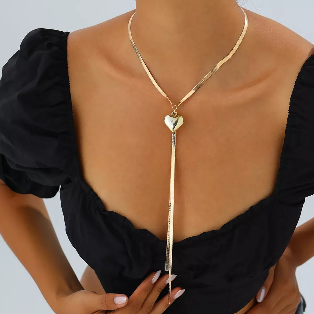 Gold-tone heart pendant lariat necklace with long chain tassels