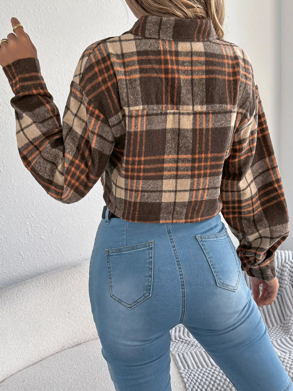 Back view of the brown plaid cropped jacket.