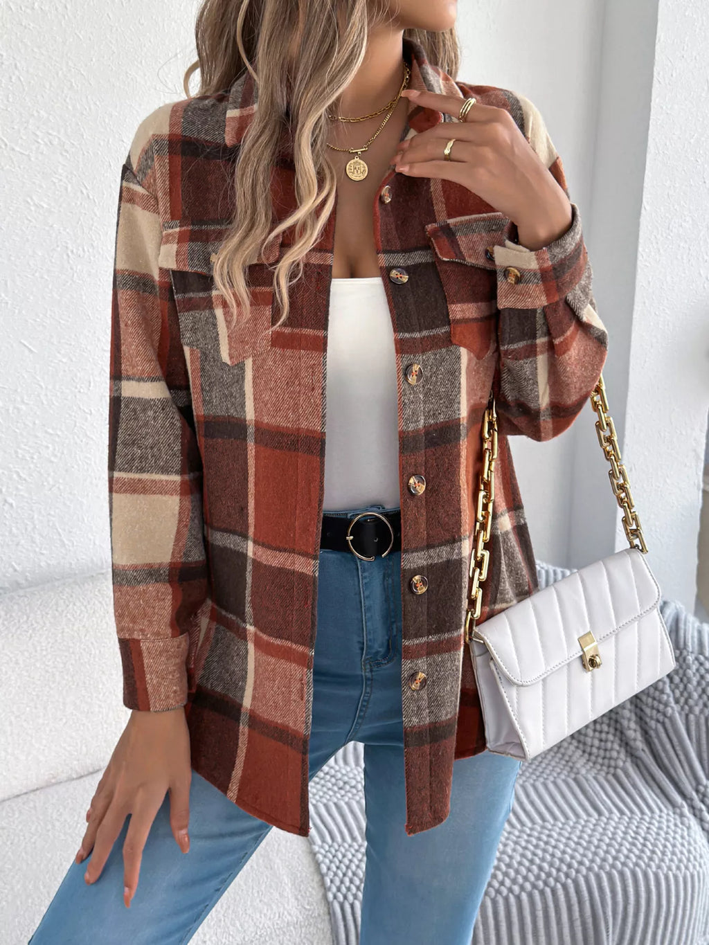 Orange plaid button-down shacket with chest pockets, front view.