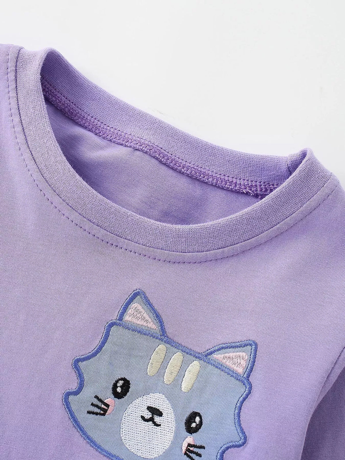 Purple ribbed crew neckline and cat graphic on the children’s sweatshirt