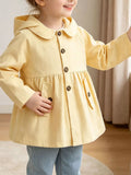 Yellow hooded peplum coat with button front worn by a child