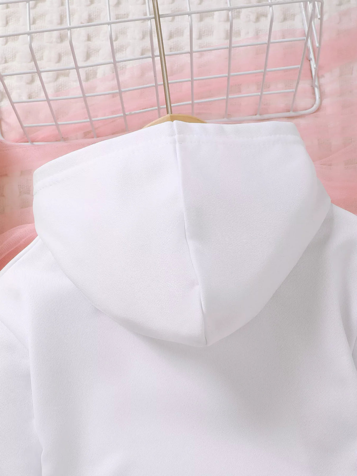 White hood and upper chest detail of the children’s graphic hoodie