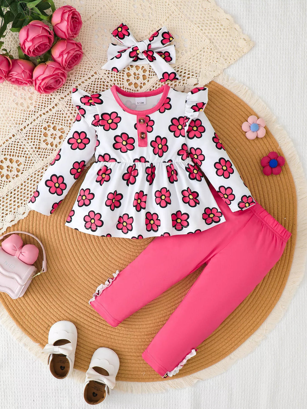 Flat lay of a white pink-floral peplum top, bright pink leggings and matching bow headband.