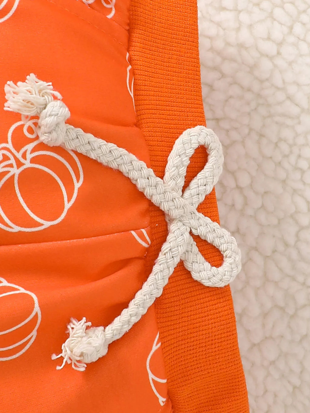 Pumpkin-print fabric and white drawstring on the orange pants