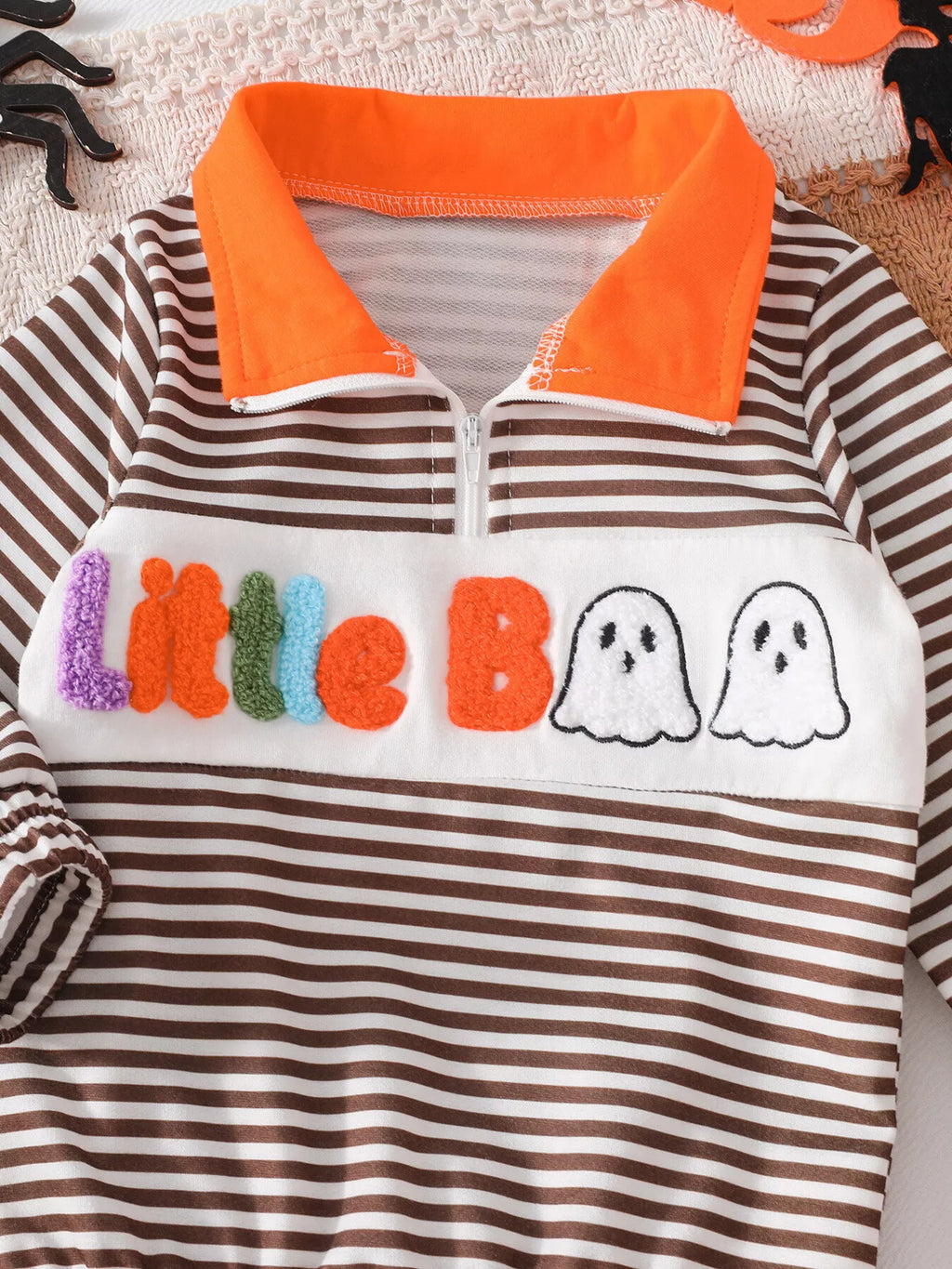 Front detail of the striped Little Boo top with multicolor letters and ghost graphics.