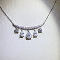Silver-tone necklace with graduated teardrop stone pendants