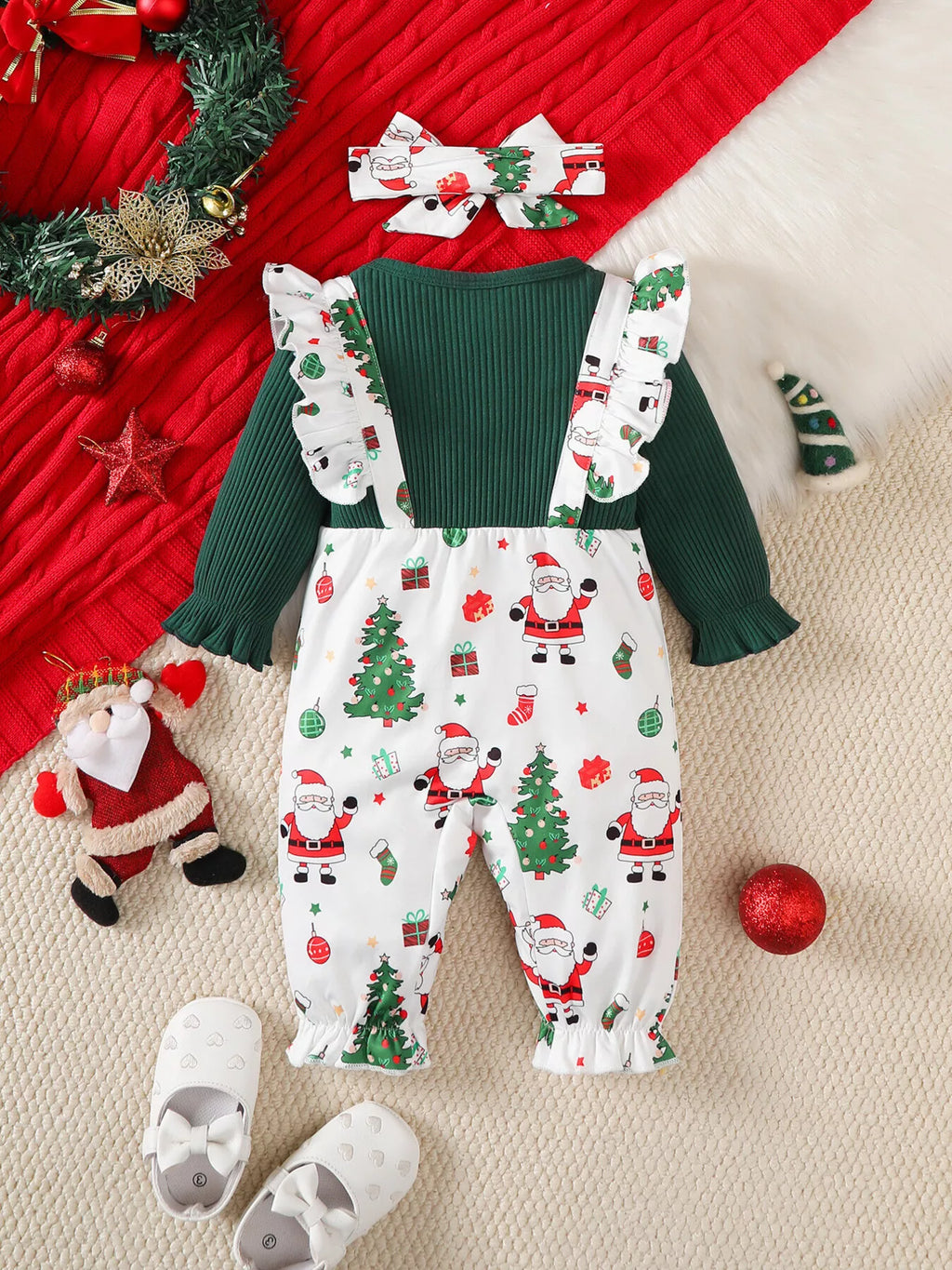 Children’s green and white Santa-print ruffle-trim jumpsuit with matching headband displayed flat
