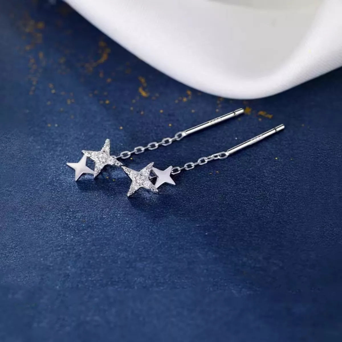 Silver-tone star earrings with long chain drops