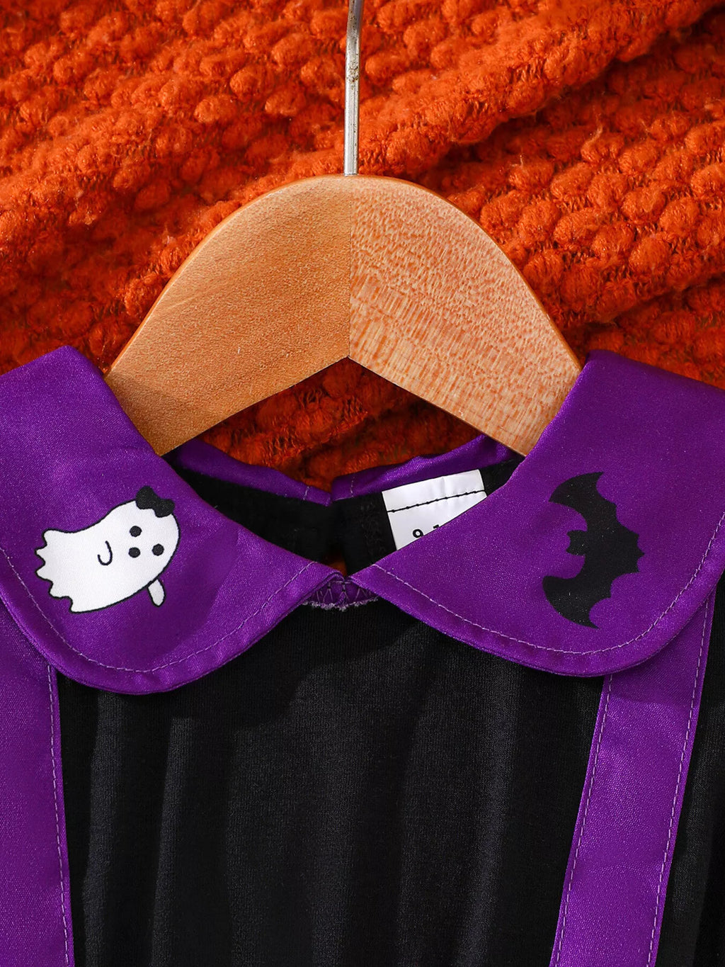 Close-up of the purple collar with ghost and bat details and black front bodice.