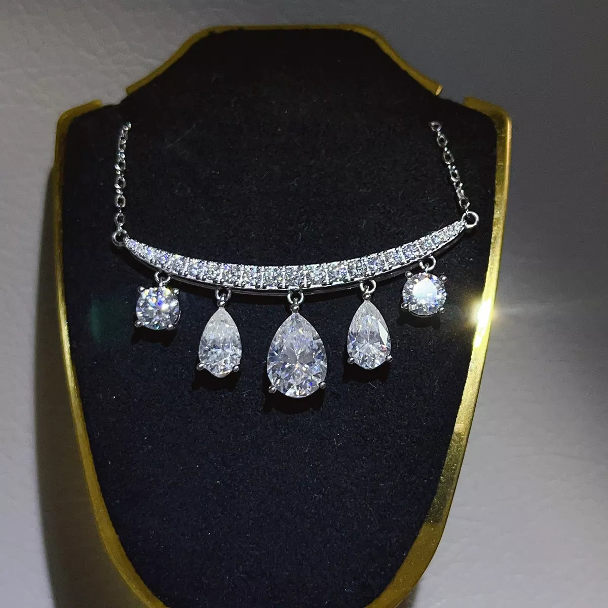 Silver-tone necklace with graduated teardrop stone pendants
